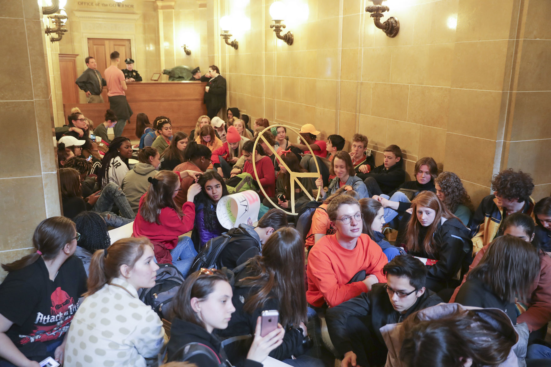 Students sit outside Gov. Scott Walker's office